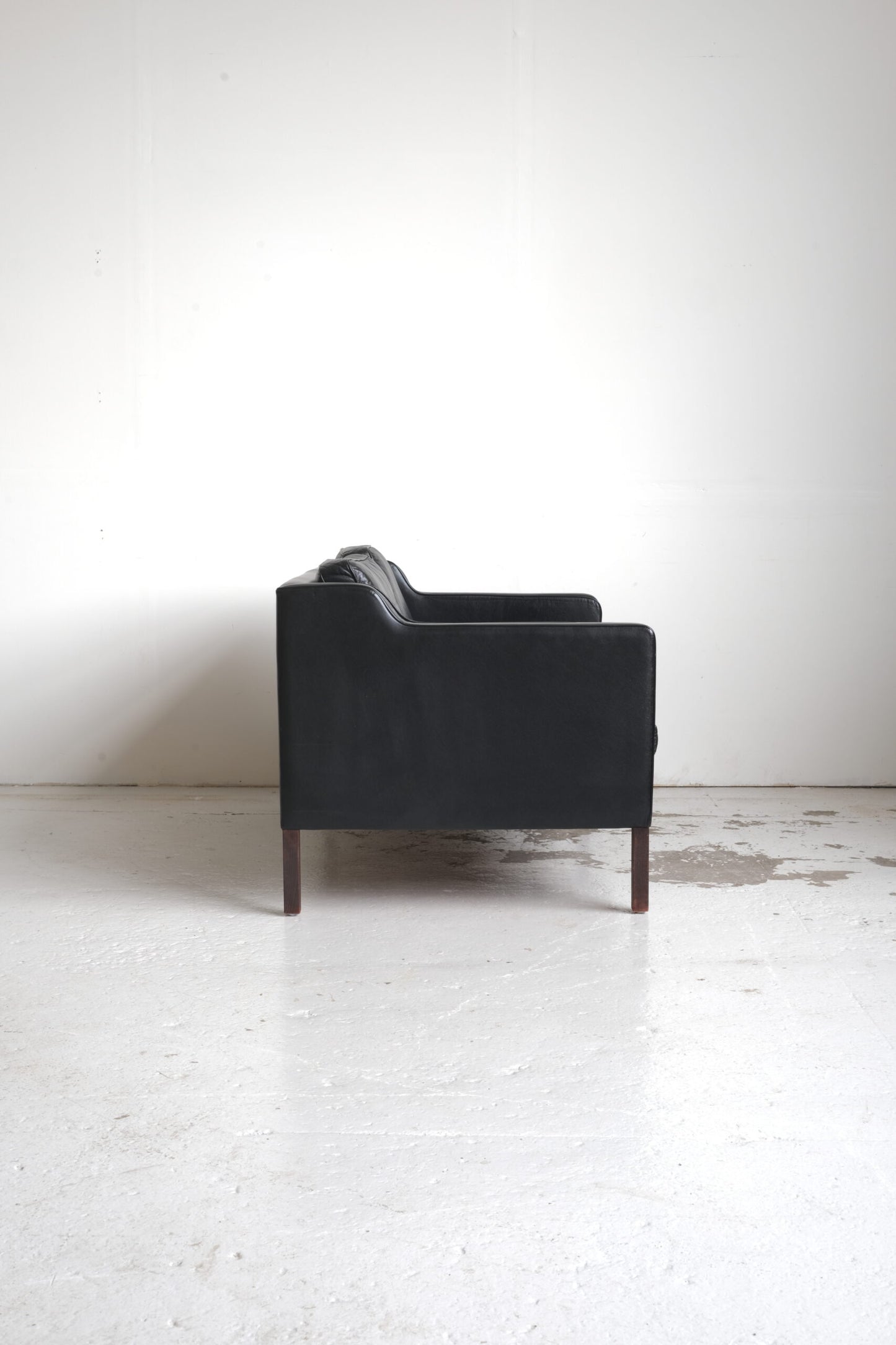 Stouby, two-seater sofa black leather