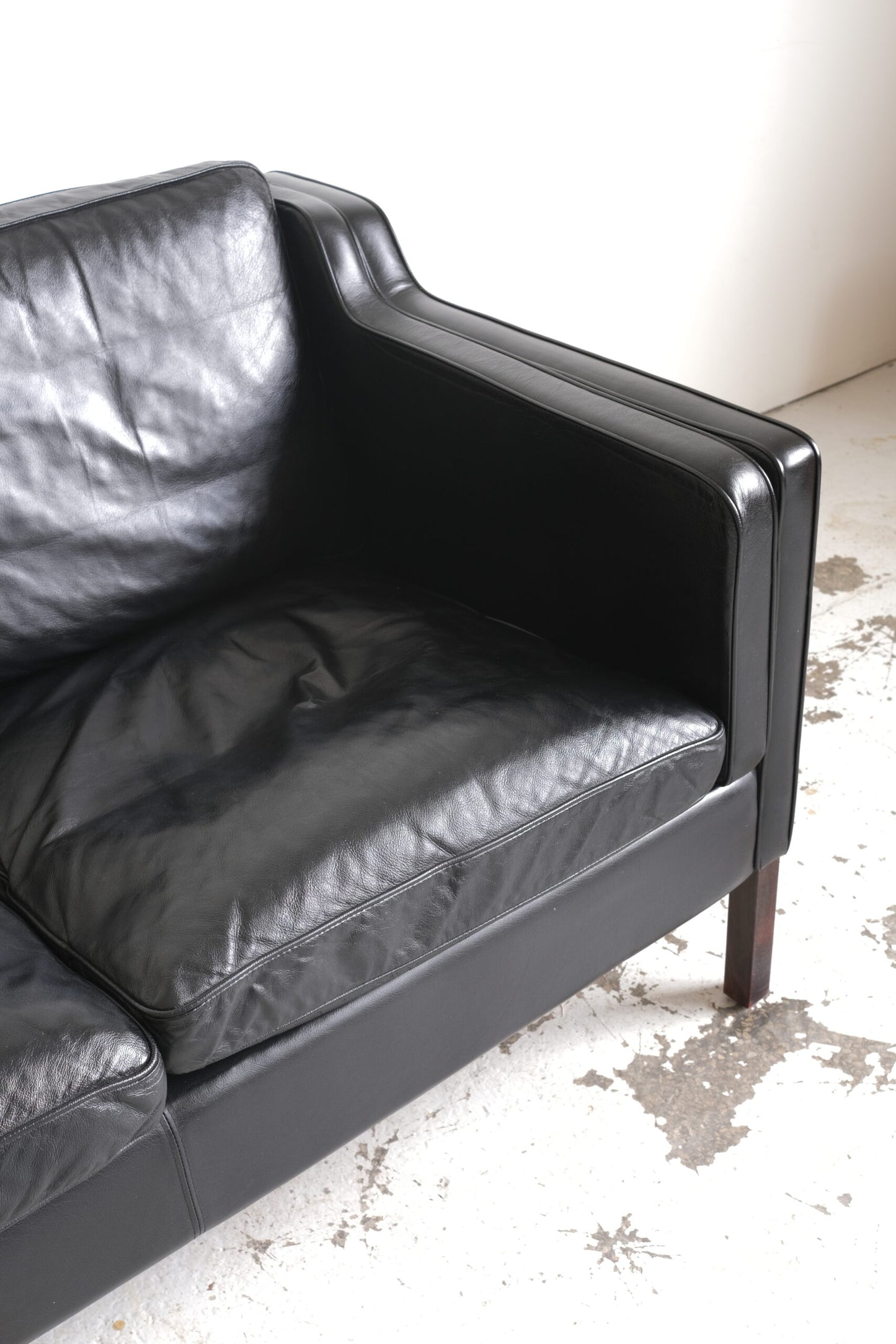 Stouby, two-seater sofa black leather