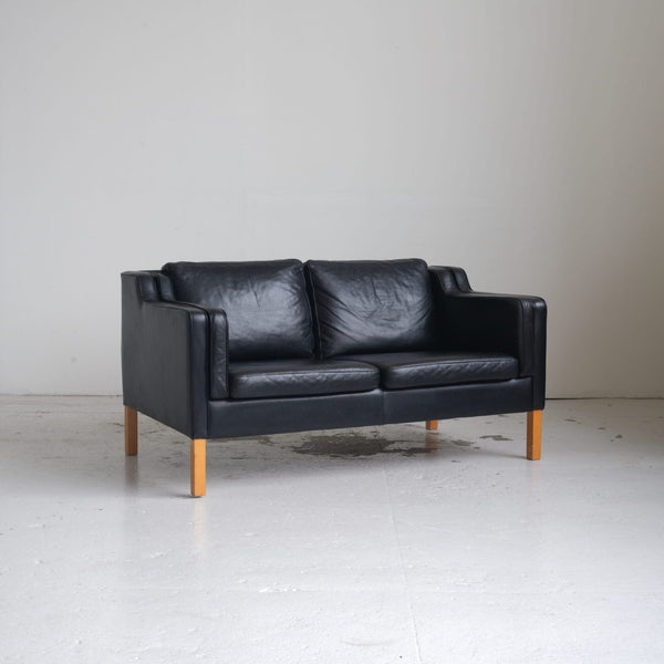 Danish furniture manufacturer. Two-person sofa, black leather