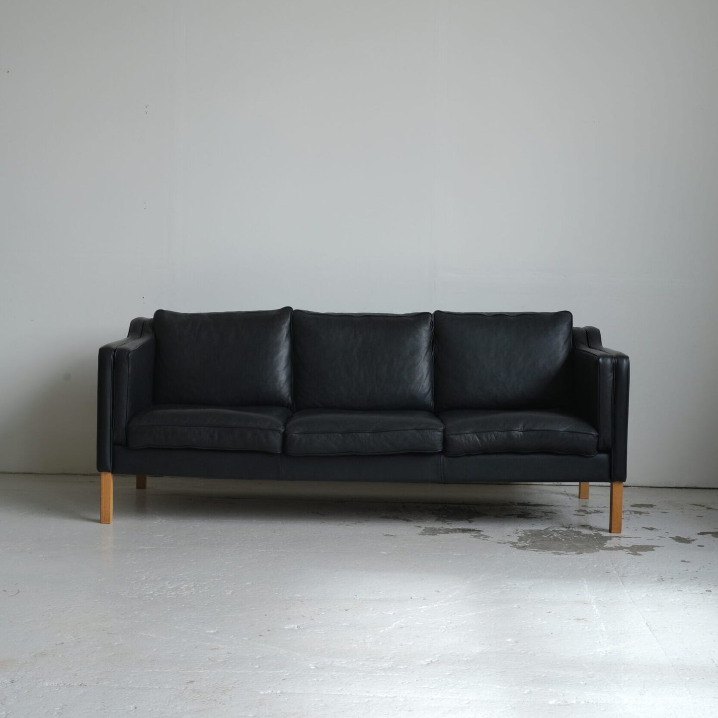 Stouby. Three-seater sofa in black leather, model 'Eva'.
