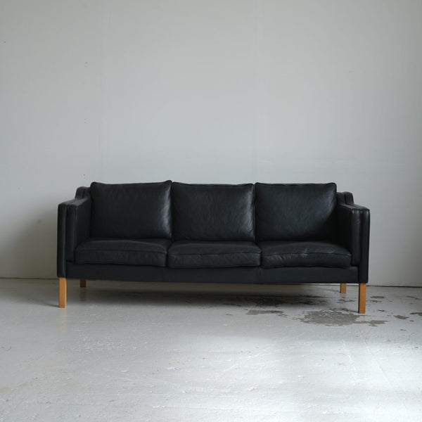 Stouby. Three-seater sofa in black leather, model 'Eva'.