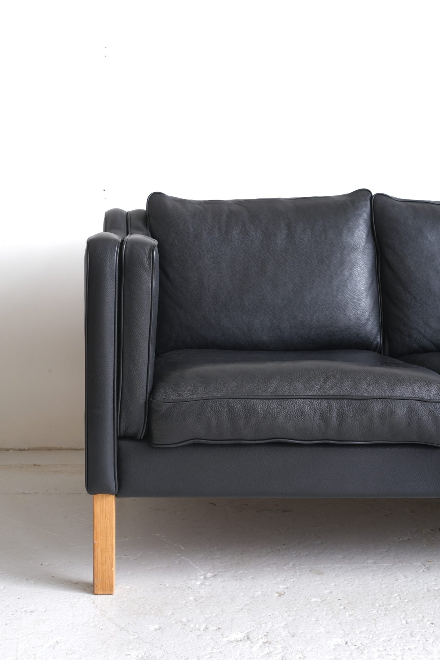Stouby. Three-seater sofa in black leather, model 'Eva'.
