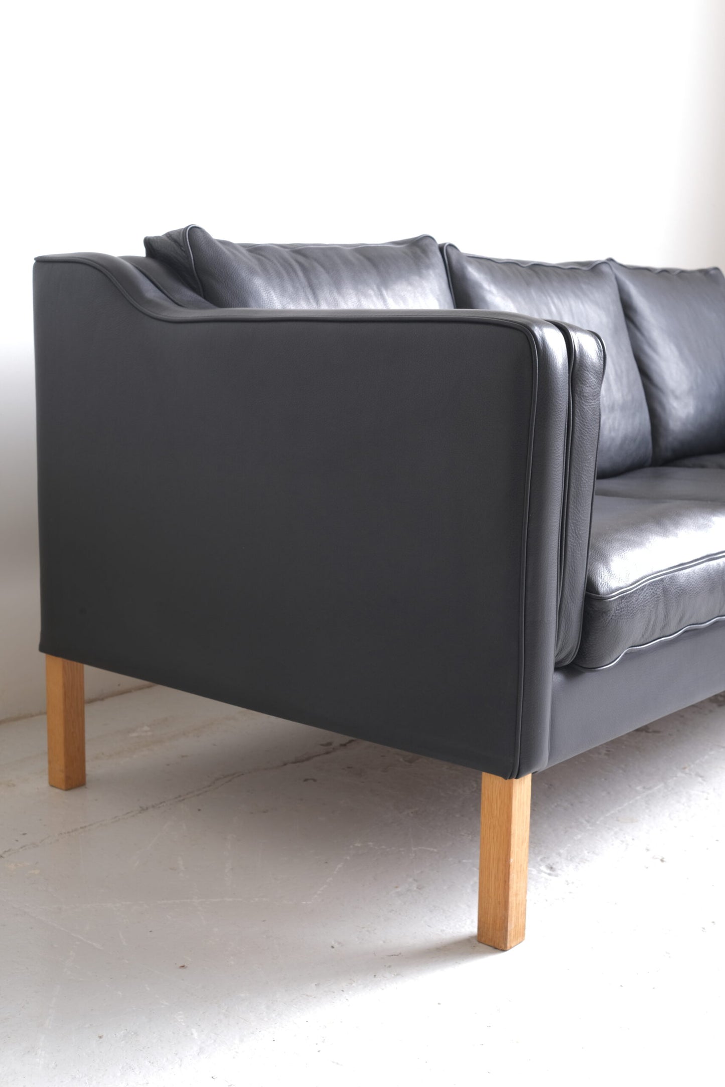 Stouby. Three-seater sofa in black leather, model 'Eva'.