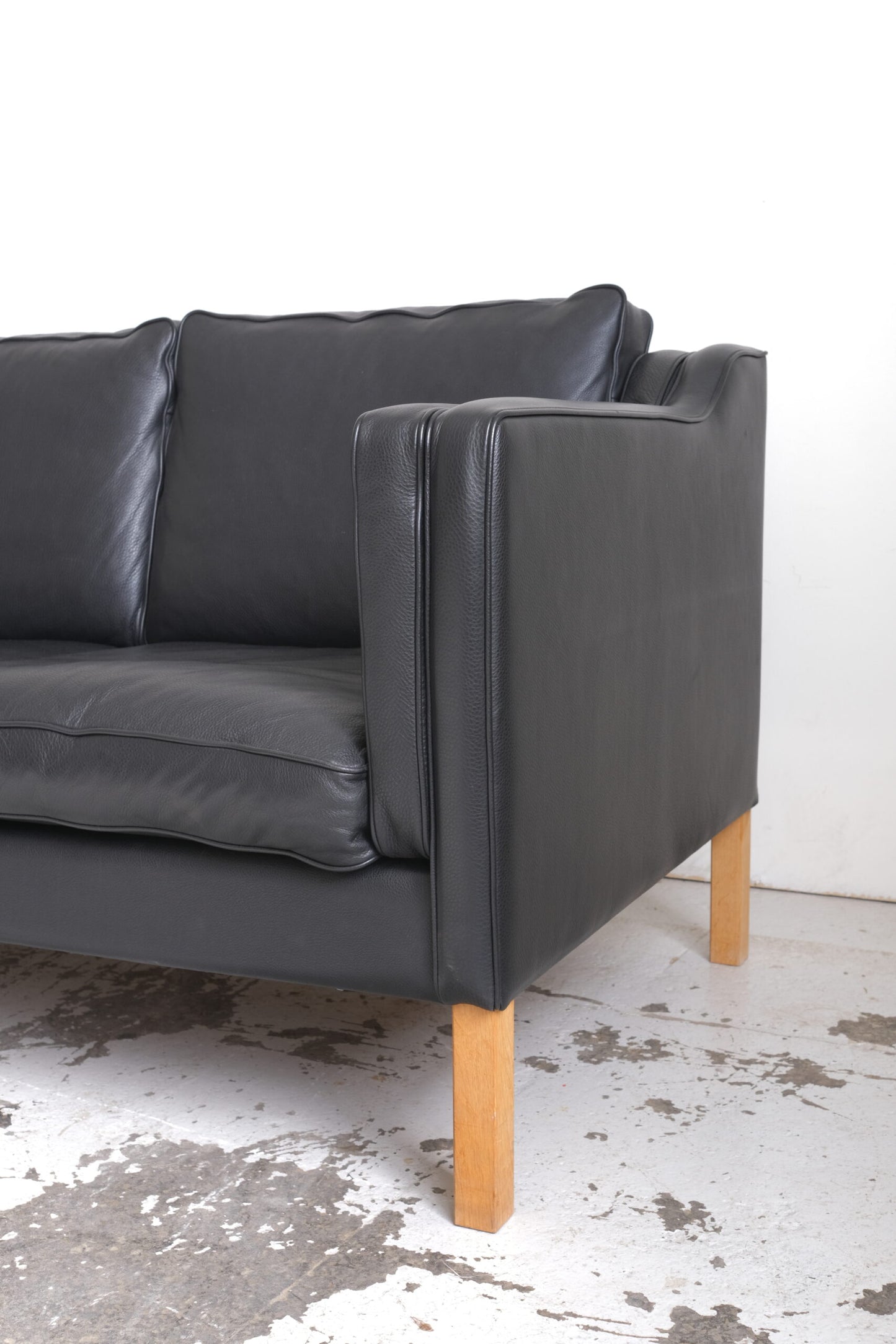 Stouby. Three-seater sofa in black leather, model 'Eva'.